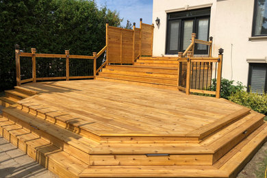 Photo of a large backyard deck in Toronto with no cover.