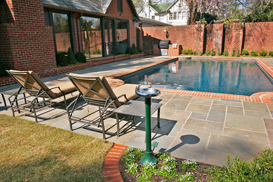 Inspiration for a mid-sized backyard decomposed granite patio remodel in Charlotte