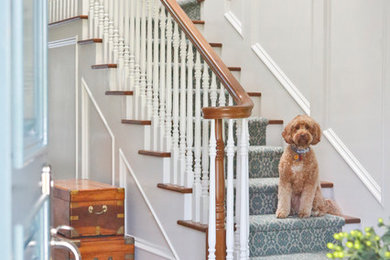 Inspiration for a mid-sized transitional carpeted l-shaped wood railing staircase remodel in Los Angeles with carpeted risers