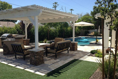 Example of a mid-sized backyard brick and rectangular lap pool house design in Phoenix