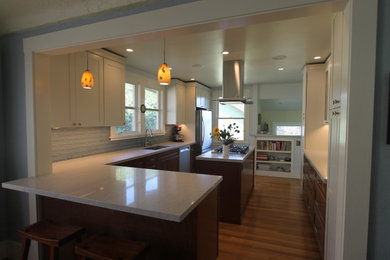 Eat-in kitchen - mid-sized transitional l-shaped medium tone wood floor and brown floor eat-in kitchen idea in San Francisco with an undermount sink, shaker cabinets, white cabinets, quartz countertops, blue backsplash, ceramic backsplash, stainless steel appliances, an island and gray countertops