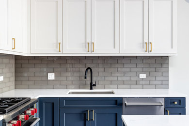 Mid-sized l-shaped eat-in kitchen photo in Boston with a drop-in sink, shaker cabinets, blue cabinets, quartz countertops, gray backsplash, glass tile backsplash, stainless steel appliances, an island and white countertops