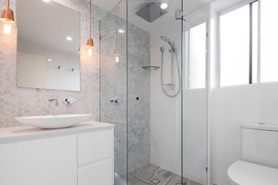 Design ideas for a mid-sized contemporary master bathroom in Gold Coast - Tweed with a corner shower, white tile, mosaic tile, grey walls, ceramic floors and engineered quartz benchtops.