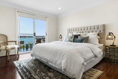 This is an example of a large contemporary master bedroom in Sydney with white walls and white floor.