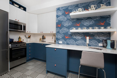 This is an example of a mid-sized contemporary l-shaped eat-in kitchen in New York with an undermount sink, flat-panel cabinets, blue cabinets, quartz benchtops, white splashback, ceramic splashback, stainless steel appliances, porcelain floors and no island.