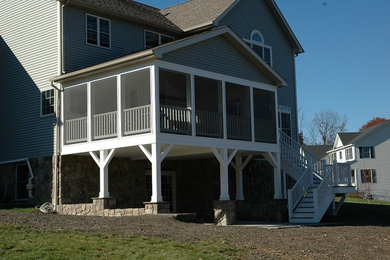 This is an example of a traditional screened-in porch design in New York.