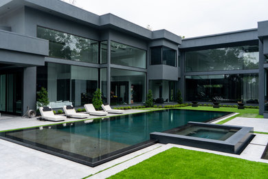 Inspiration for a large modern courtyard stone and rectangular privacy pool remodel in Houston