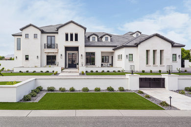Huge transitional white three-story stucco house exterior idea in Phoenix