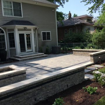 Outdoor Living Space with Gas Fire Pit and Lush Landscapes