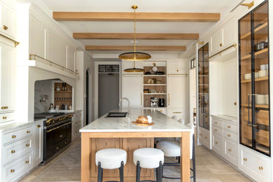 Inspiration for a large transitional u-shaped exposed beam enclosed kitchen remodel in Milwaukee with an undermount sink, recessed-panel cabinets, medium tone wood cabinets, quartzite countertops, stone slab backsplash, colored appliances and an island