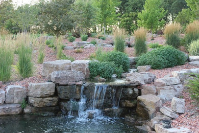 Photo of a traditional full sun backyard stone formal garden in Other.
