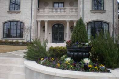 Photo of a mid-sized two-storey beige exterior in Dallas with stone veneer.