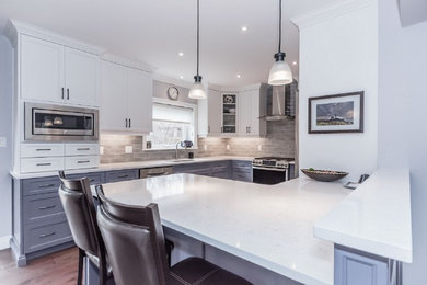 This is an example of a small modern l-shaped kitchen in Toronto with a built-in sink, white cabinets, grey splashback and ceramic splashback.
