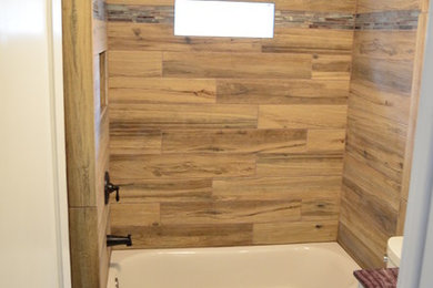 Mid-sized cottage kids' brown tile and porcelain tile vinyl floor alcove bathtub photo in Philadelphia with recessed-panel cabinets, white cabinets, a two-piece toilet, green walls, an undermount sink and marble countertops