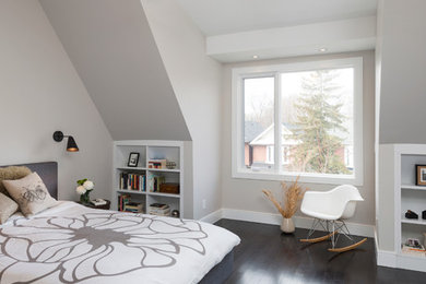 Photo of a mid-sized contemporary loft-style bedroom in Toronto with white walls and dark hardwood floors.