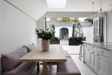 Design ideas for a large transitional u-shaped eat-in kitchen in London with marble benchtops, white splashback, with island, grey benchtop, shaker cabinets, grey cabinets, ceramic floors and grey floor.