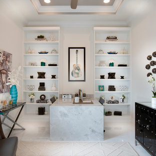 Contemporary study room in Miami with white walls and a built-in desk.