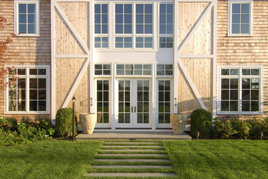 Elegant two-story wood exterior home photo in New York