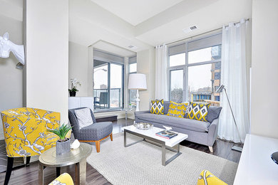 Inspiration for a small contemporary open concept medium tone wood floor living room remodel in Ottawa with white walls