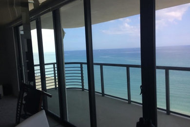 Photo of a mid-sized beach style balcony in Miami with an awning.