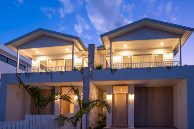 Inspiration for a large modern two-storey white duplex exterior in Sydney with wood siding, a gable roof, a metal roof and a white roof.
