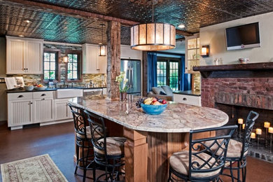 This is an example of a large country l-shaped eat-in kitchen in New York with a farmhouse sink, beaded inset cabinets, white cabinets, granite benchtops, green splashback, matchstick tile splashback, stainless steel appliances, medium hardwood floors, with island and brown floor.