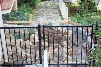 Design ideas for a mid-sized modern shade hillside concrete paver retaining wall landscape in Austin for summer.