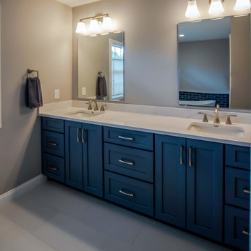 Primary Bathroom with Blue-Gray Vanity and Deep Blue Tiled Feature Wall
