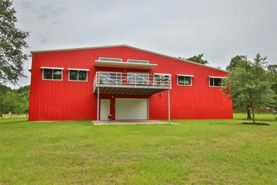 Inspiration for a large coastal red two-story metal exterior home remodel in Houston with a metal roof and a gray roof