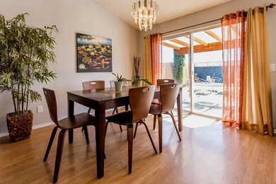 Inspiration for a mid-sized contemporary laminate floor and beige floor enclosed dining room remodel in Los Angeles with gray walls