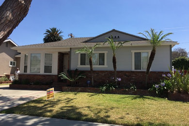 Inspiration for a mid-sized timeless gray one-story wood gable roof remodel in Los Angeles
