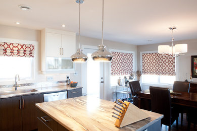 Inspiration for a mid-sized contemporary u-shaped eat-in kitchen remodel in Other with an undermount sink, flat-panel cabinets, white backsplash, subway tile backsplash, stainless steel appliances and an island