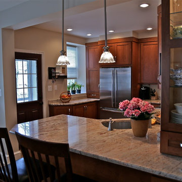 Warm Wood Kitchen Remodel | Angled Granite Island & Integrated Display Cabinets