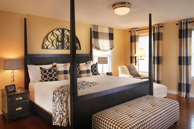 Inspiration for a mid-sized timeless master medium tone wood floor and brown floor bedroom remodel in Boston with yellow walls and no fireplace