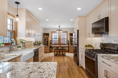 Kitchen - huge transitional galley medium tone wood floor kitchen idea in Minneapolis with a farmhouse sink, shaker cabinets, light wood cabinets, multicolored backsplash, ceramic backsplash, stainless steel appliances and a peninsula