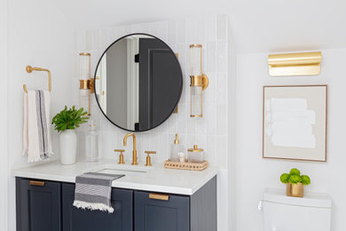 Example of a mid-sized trendy master white tile and subway tile mosaic tile floor, black floor and single-sink doorless shower design in Charleston with black cabinets, a one-piece toilet, white walls, quartzite countertops, a hinged shower door, white countertops and a built-in vanity