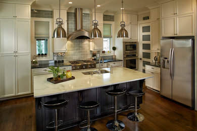 Open concept kitchen - large transitional l-shaped dark wood floor open concept kitchen idea in Other with a double-bowl sink, recessed-panel cabinets, gray backsplash, ceramic backsplash, stainless steel appliances, an island and white cabinets