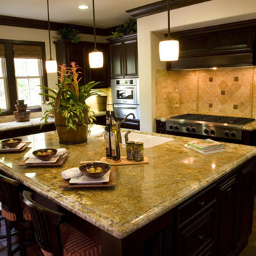 Kashimier Gold granite countertop with travertine back splashes