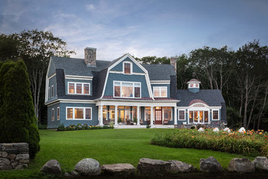 Traditional two-storey blue exterior in Portland Maine with wood siding and a gambrel roof.