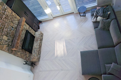 Inspiration for a modern loft-style living room remodel in Charlotte with a standard fireplace and a stone fireplace