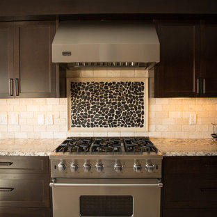 Modern kitchen pantry photos - Inspiration for a modern galley ceramic floor kitchen pantry remodel in Calgary with a drop-in sink, flat-panel cabinets, dark wood cabinets, granite countertops, beige backsplash, stone tile backsplash, stainless steel appliances and no island