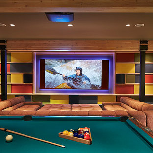 Inspiration for an expansive modern enclosed home cinema in Seattle with multi-coloured walls, concrete flooring and a projector screen.