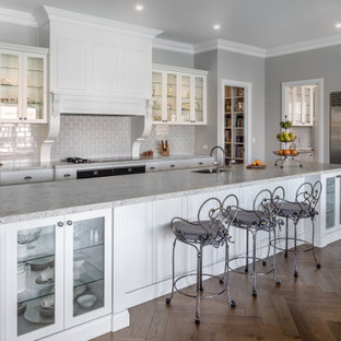 Traditional galley kitchen in Perth with an undermount sink, shaker cabinets, white cabinets, granite benchtops, grey splashback, subway tile splashback, dark hardwood floors, with island and grey benchtop.