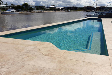 Inspiration for a large modern backyard custom-shaped natural pool in Sunshine Coast.