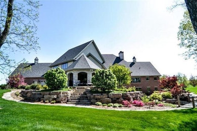 Example of a large transitional red two-story brick exterior home design in Chicago with a shingle roof