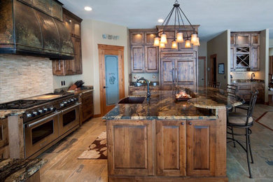 Country kitchen in Other with a farmhouse sink, raised-panel cabinets, dark wood cabinets and granite benchtops.