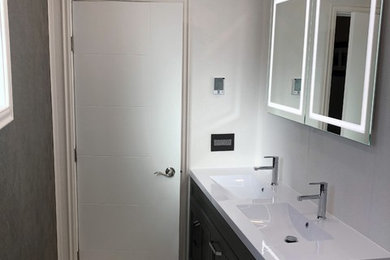 Bathroom - mid-sized modern master white tile ceramic tile and white floor bathroom idea in Other with furniture-like cabinets, brown cabinets, a two-piece toilet, white walls, an integrated sink, soapstone countertops and white countertops