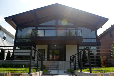 Inspiration for a large transitional multicolored two-story mixed siding exterior home remodel in Denver with a green roof