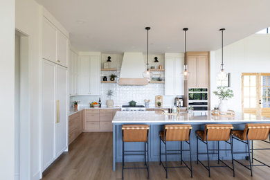 Large transitional l-shaped eat-in kitchen photo in Portland with an island