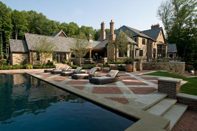 Mid-sized elegant backyard brick patio photo in Cleveland with no cover
